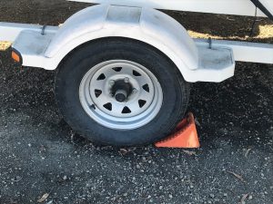 Blocking the trailer wheel is how to winterize a boat.